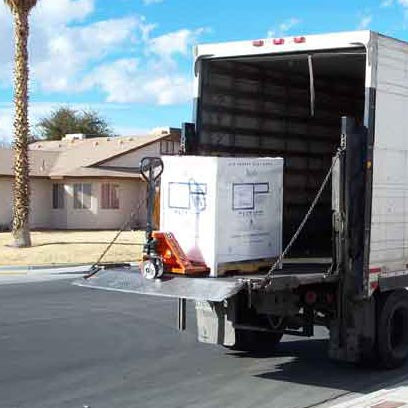 Transformer on liftgate being loaded into truck
